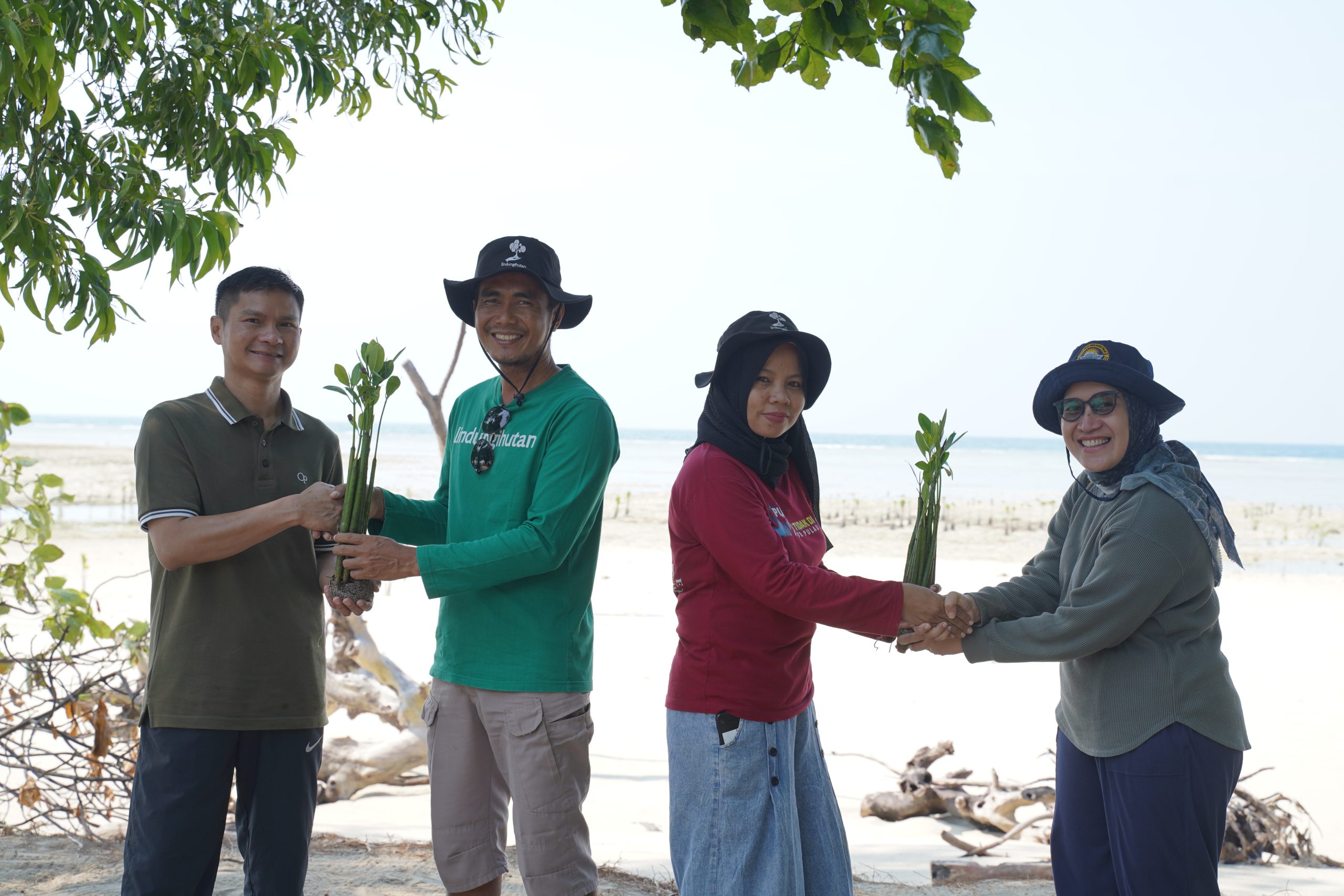 Penyerahan Bibit Mangrove oleh Deputi Direktur Bank Indonesia, Nasrullah dan Asisten Direktur Ida Farida, kepada Edy Hafiz selaku Ketua Kelompok Forum Peduli Pulau Pari dan Teh Aas Perwakilan Ibu Tani